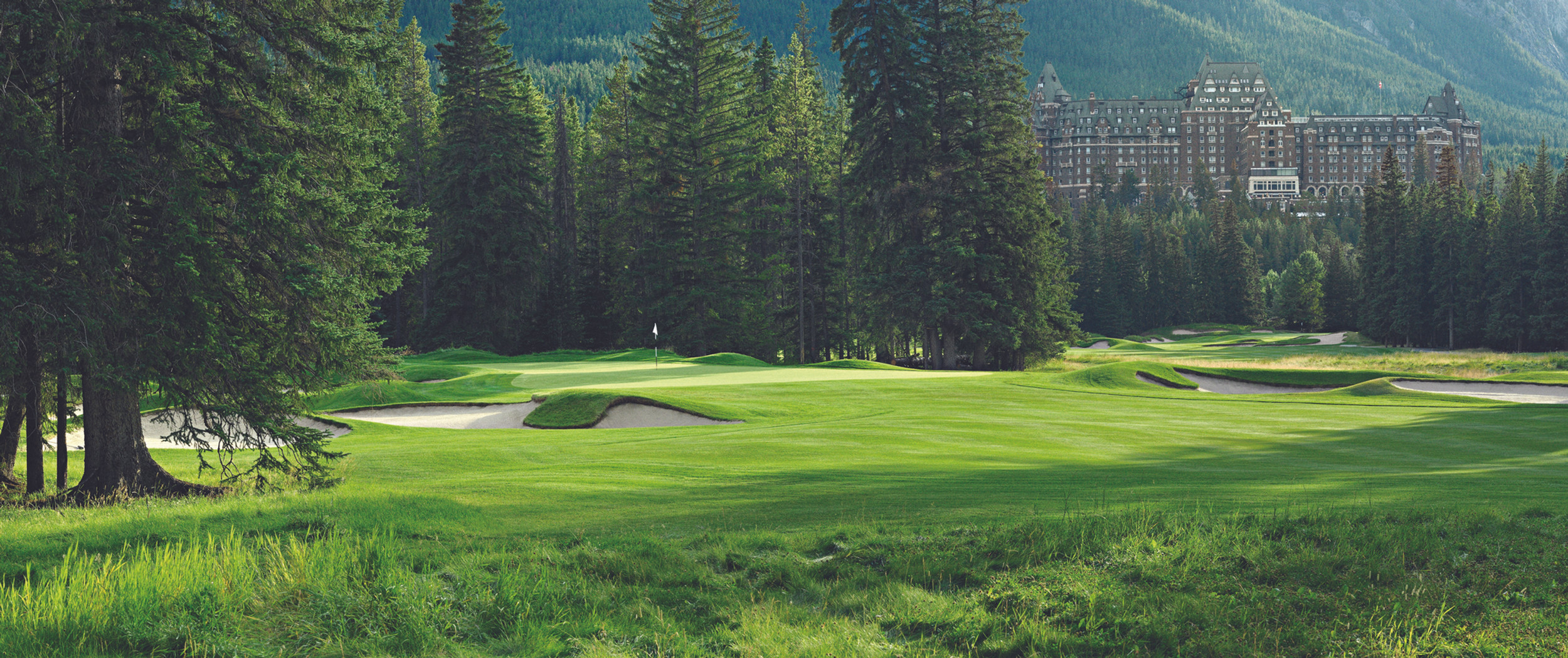 Banff Springs golf course with the Fairmont Banff Springs hotel behind the trees